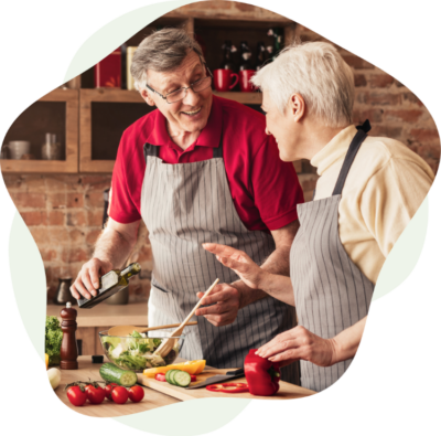 A photo of an elderly couple cooking.